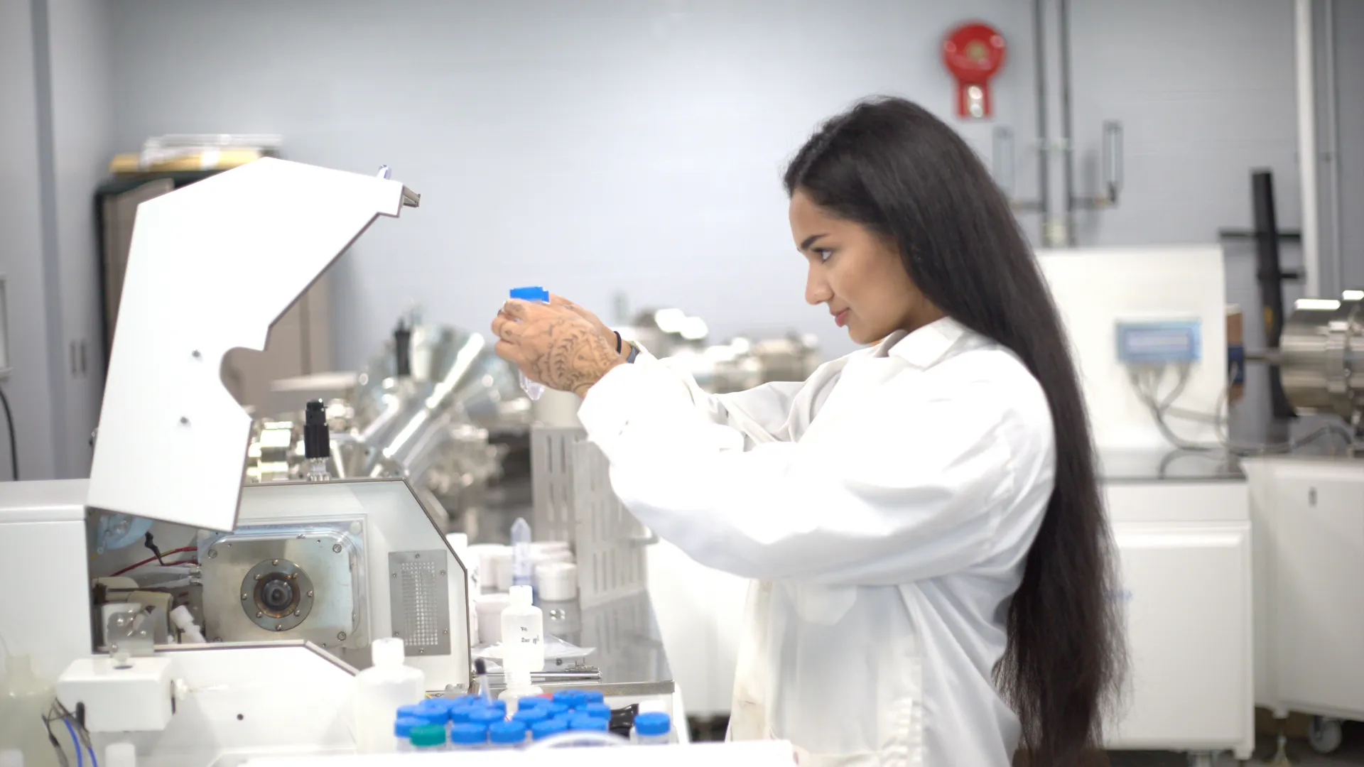 A student examines a solution after it was run through a machine