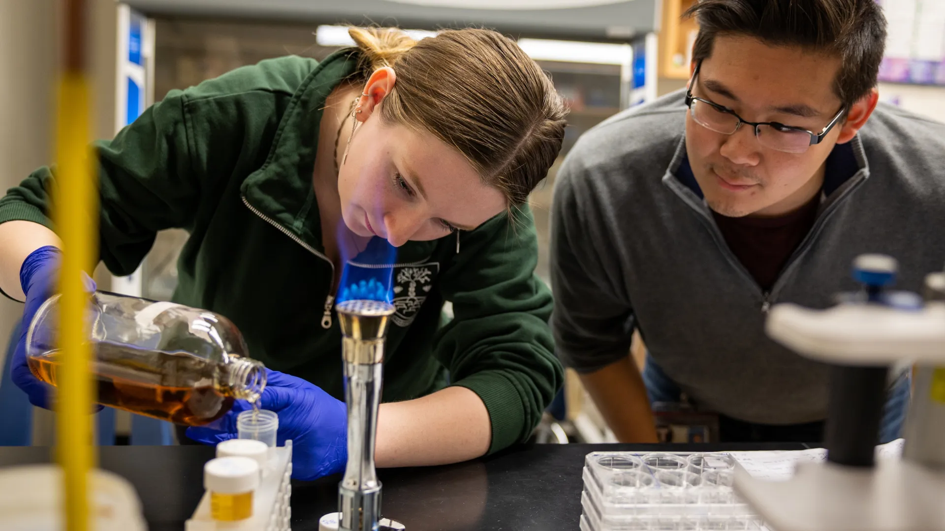 Trent students work together measuring solutions in a lab