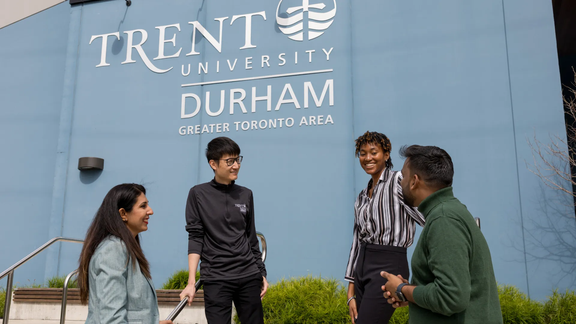 Four students talk outside of the Trent Durham GTA campus