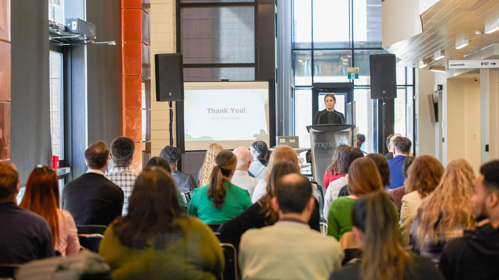 A communications student gives a presentation to students, faculty and community members