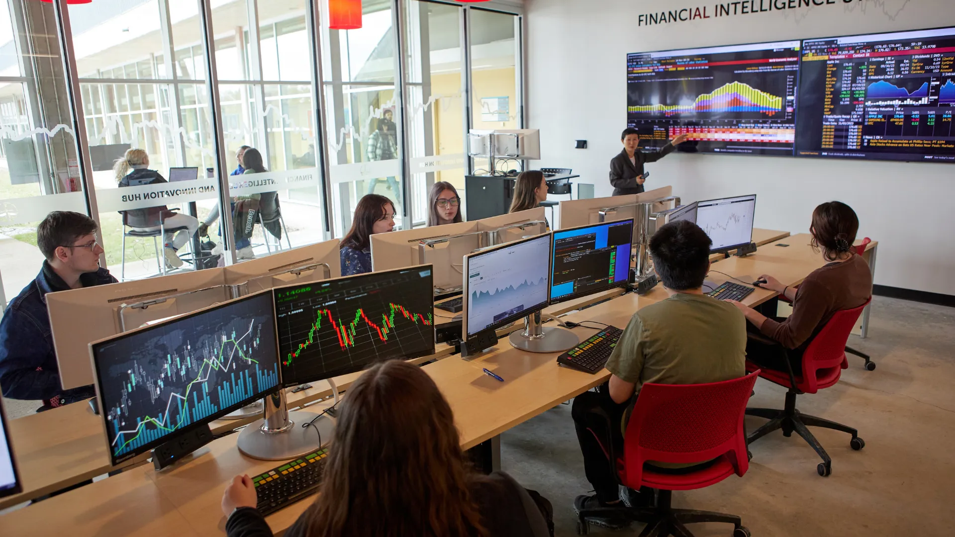 Trent students listen to a professor in the Financial Intelligence & Innovation Hub at the Durham GTA campus