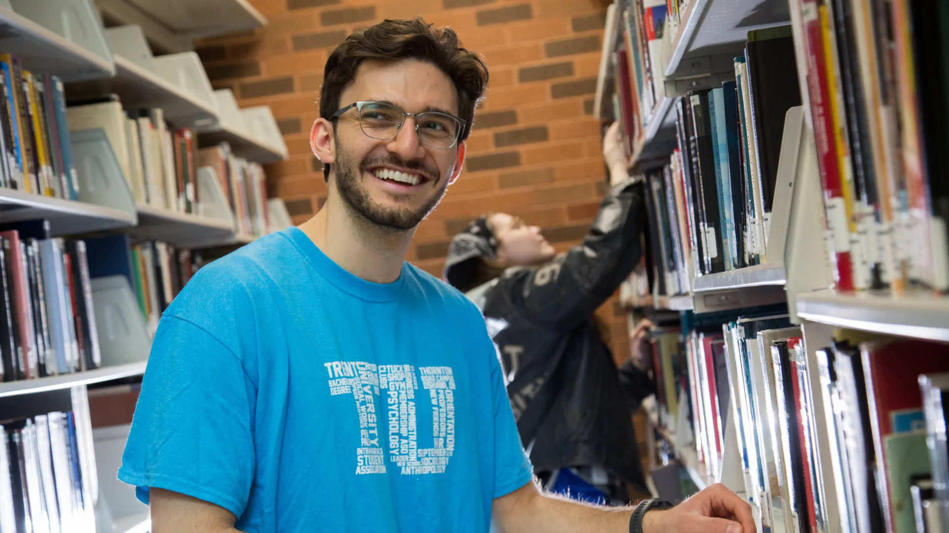 A Trent student poses for a photo in the Trent Durham Library