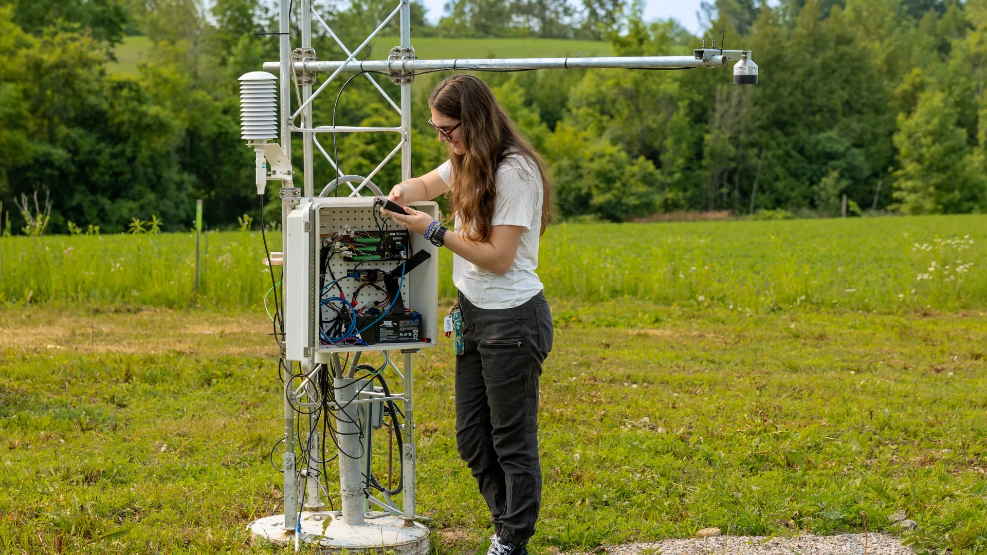 A Trent student takes readings from the Trent weather station