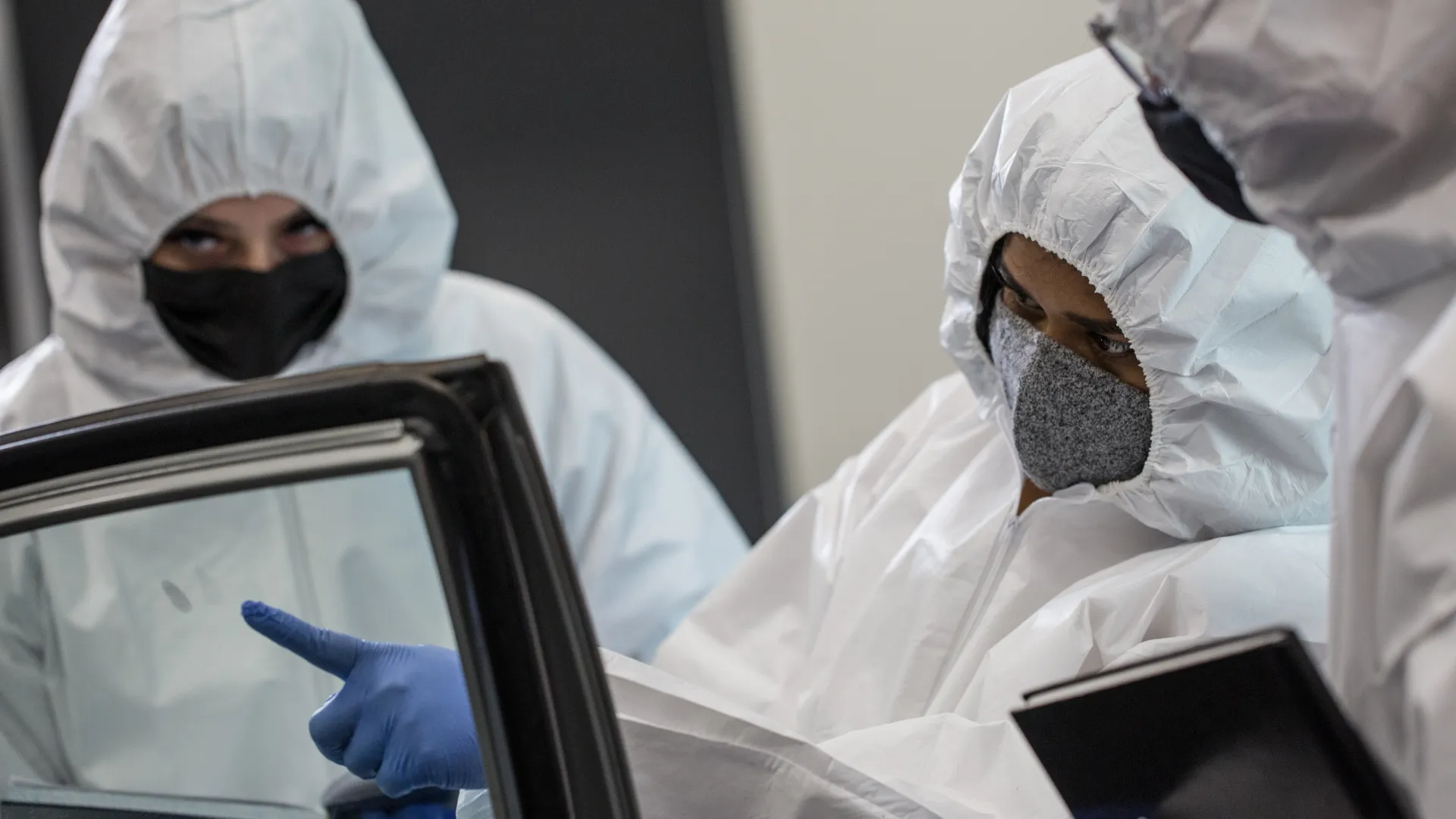 Forensic science students examine a fingerprint on a car window