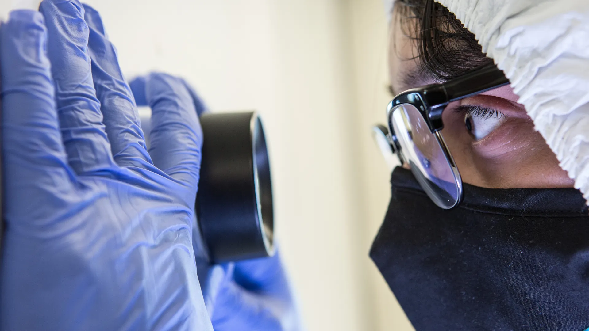 Forensic Science student looks through a lens