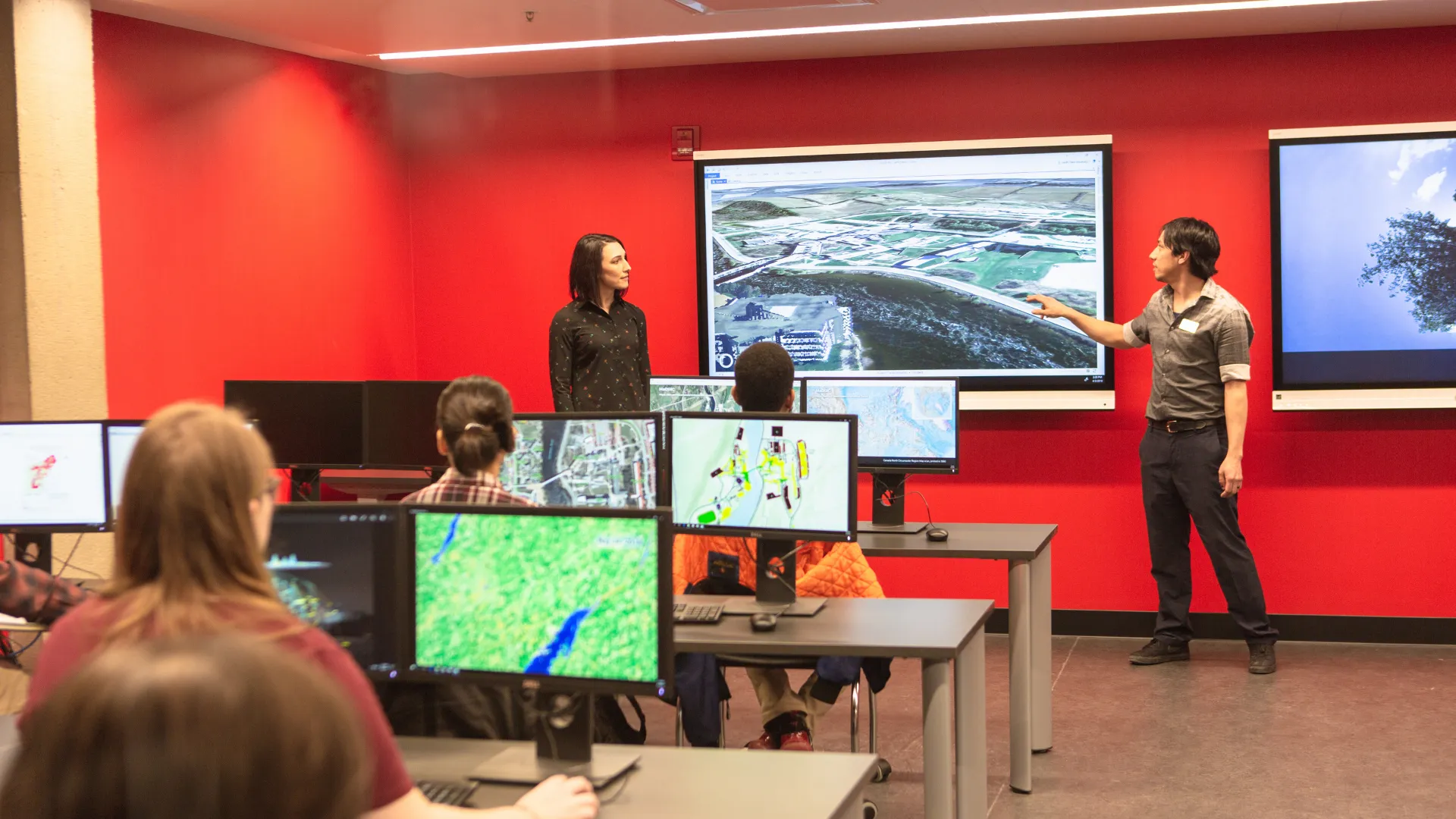 Trent students watching a demonstration in the Maps, Data & Government Information Centre (MaDGIC) in the Bata Library