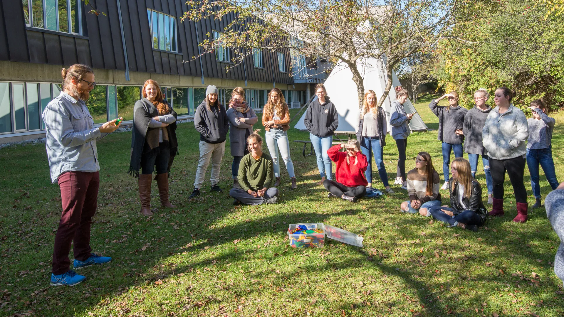 A Trent class listens to a professor outside at the Durham GTA campus