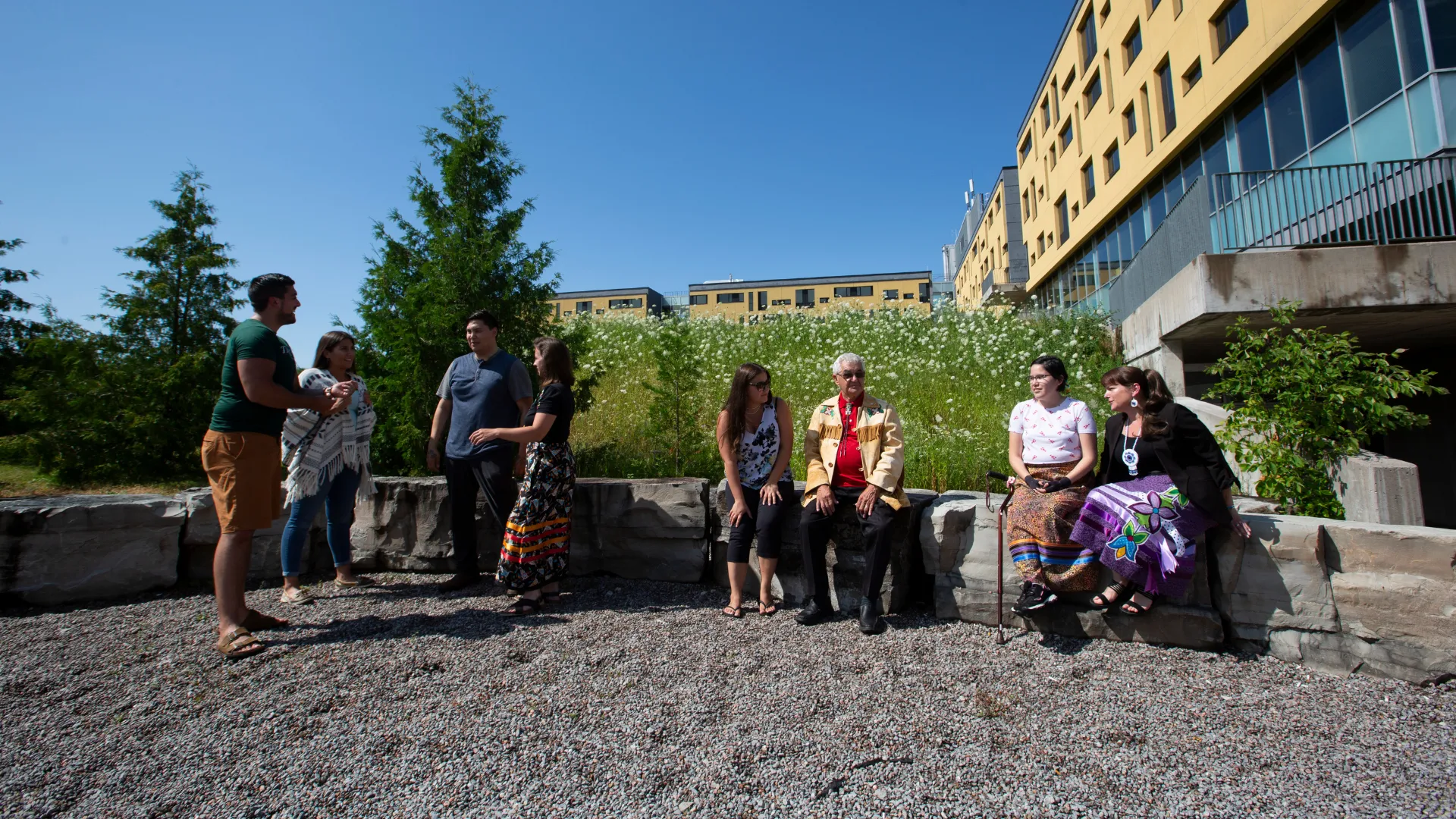 Trent students, faculty and community members talk outside Gzowski college on the Peterborough campus