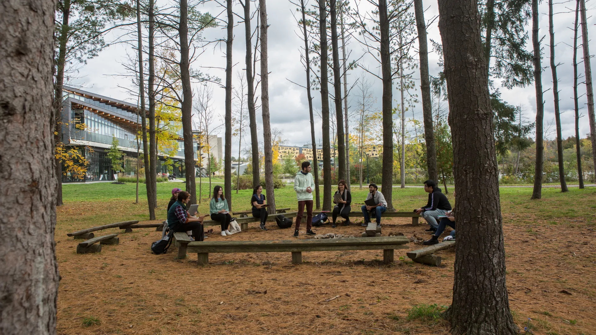 Trent students talking in an outdoor space on the Peterborough campus