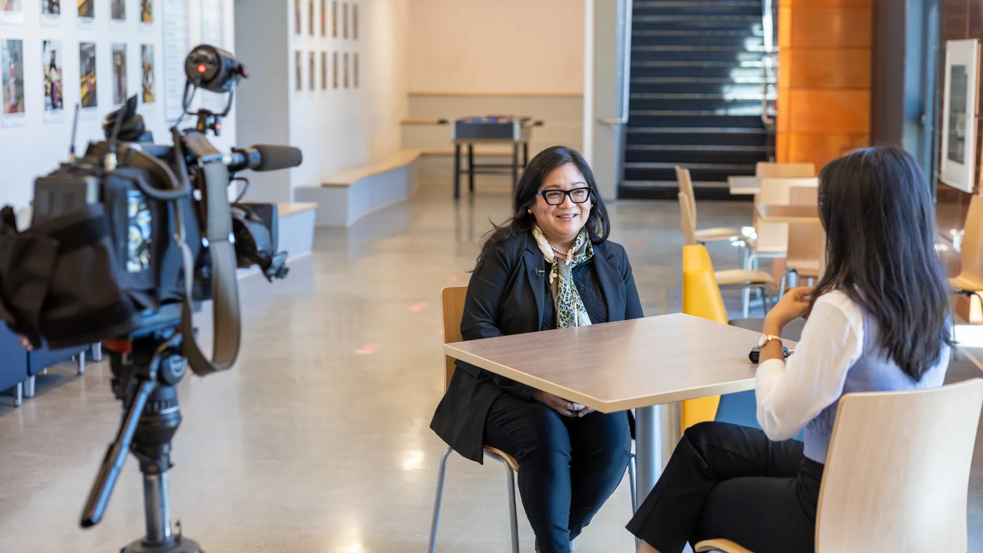 A Trent student conducts an interview with a video camera set up in the foreground