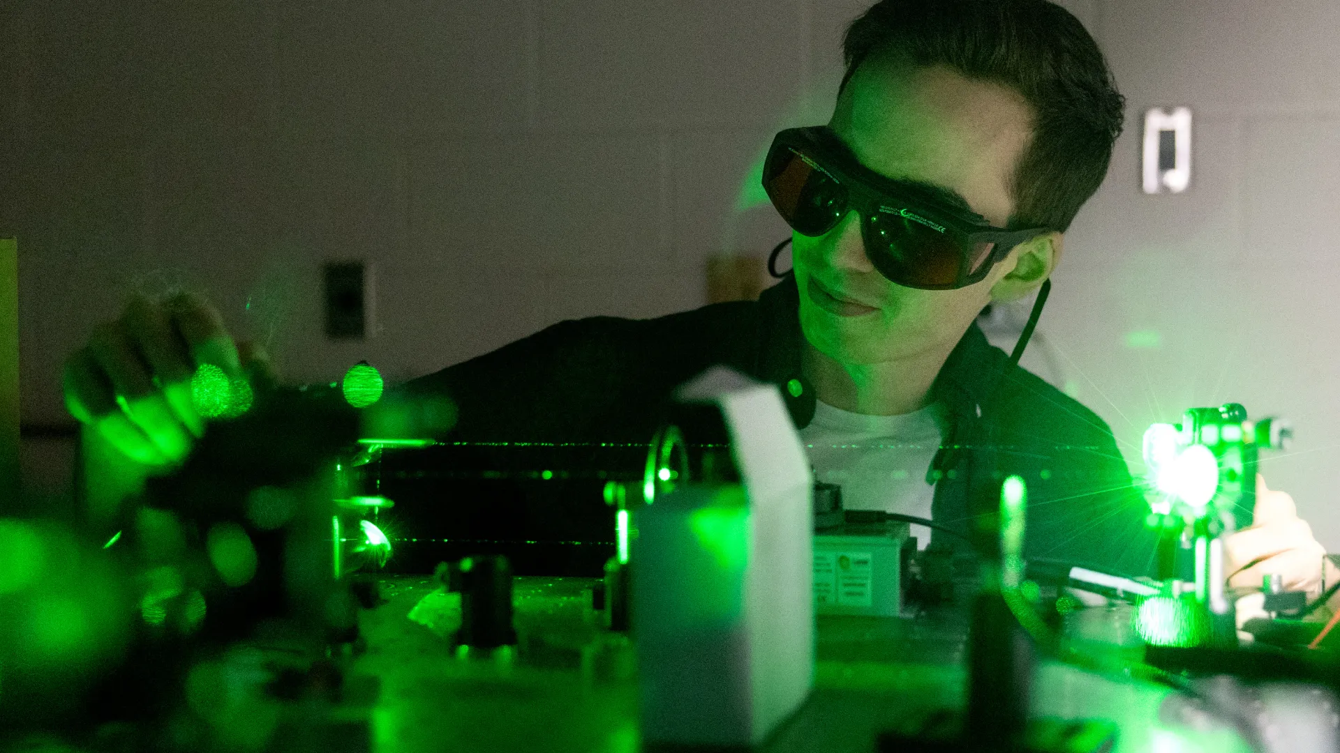 Student conducting an experiment with lasers