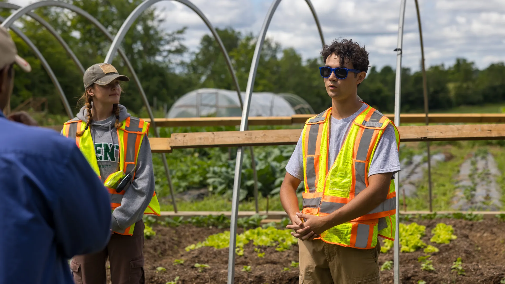 Trent students giving a presentation outdoors at the Trent farm