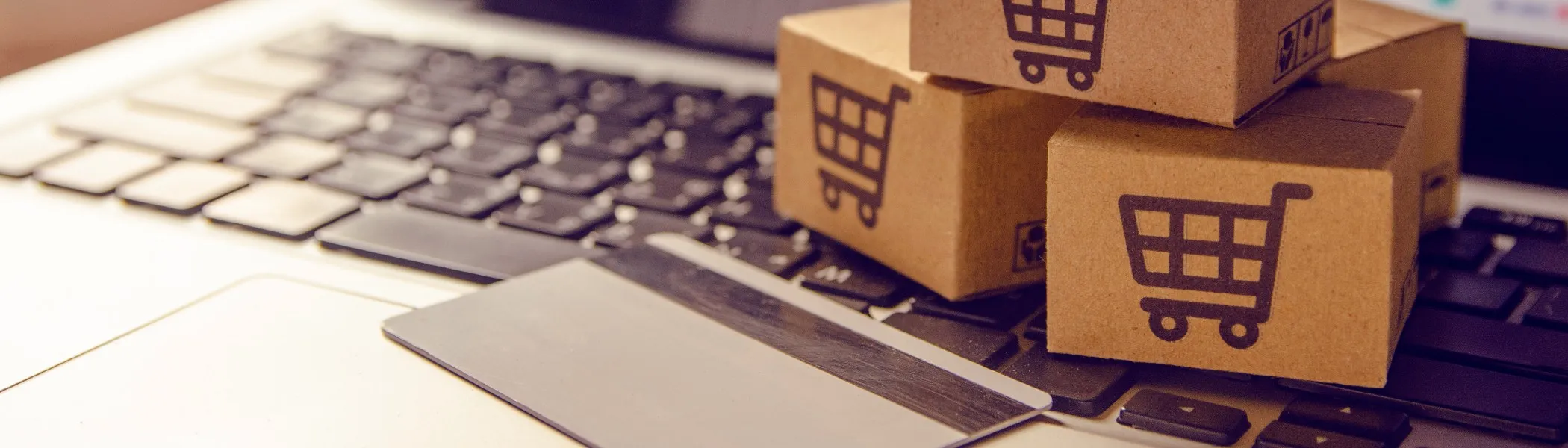 Small shipping boxes sitting on a computer keyboard