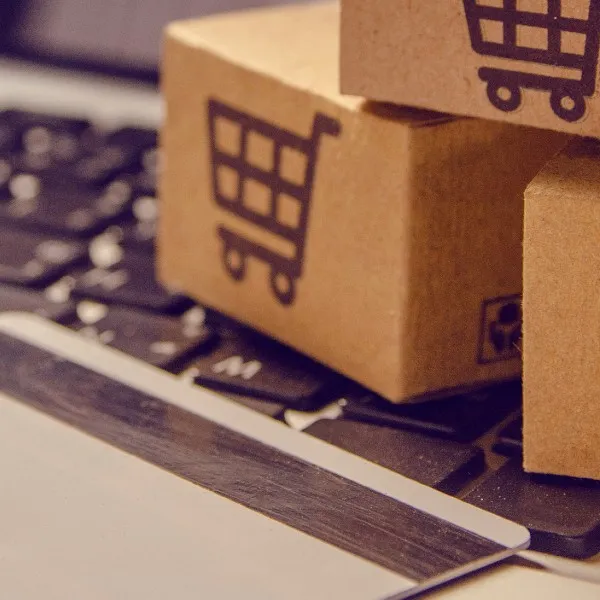 Small shipping boxes sitting on a computer keyboard