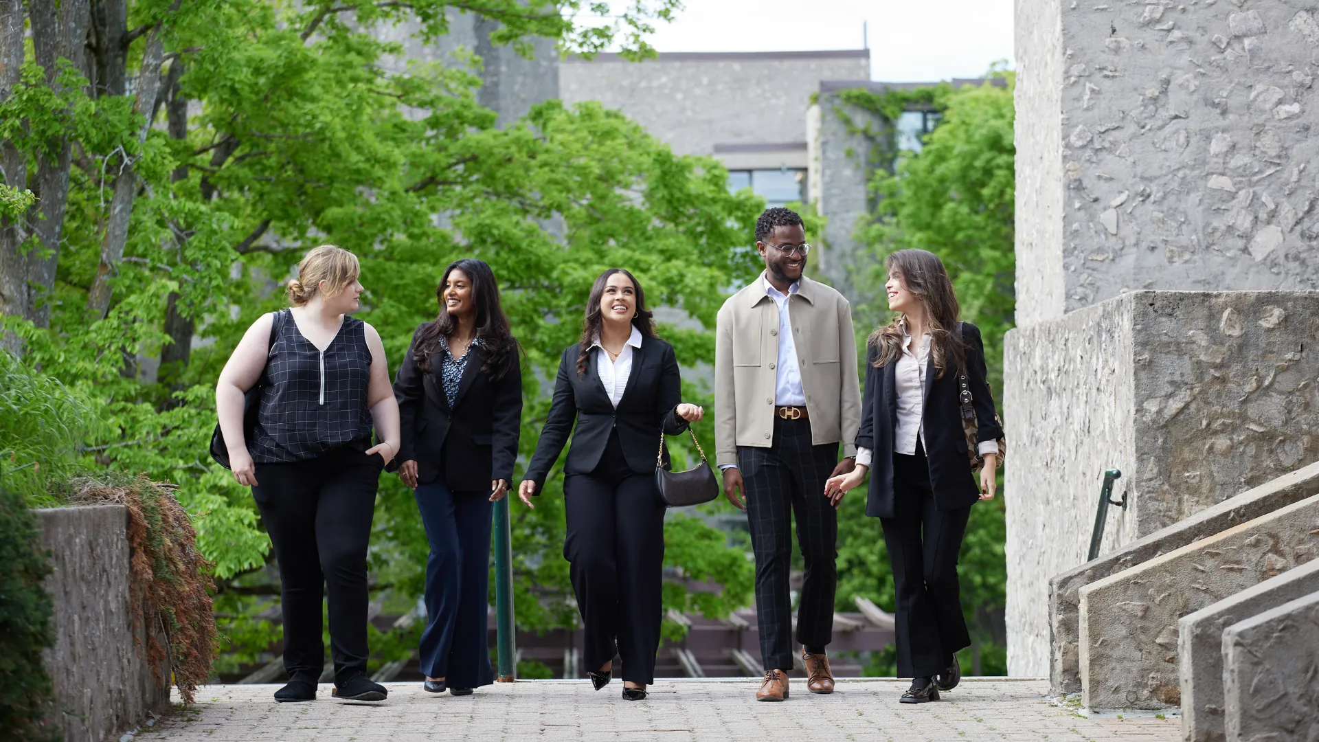 Students walking outside talking.