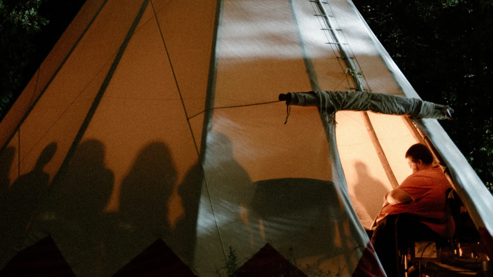Group talking inside of tipi.