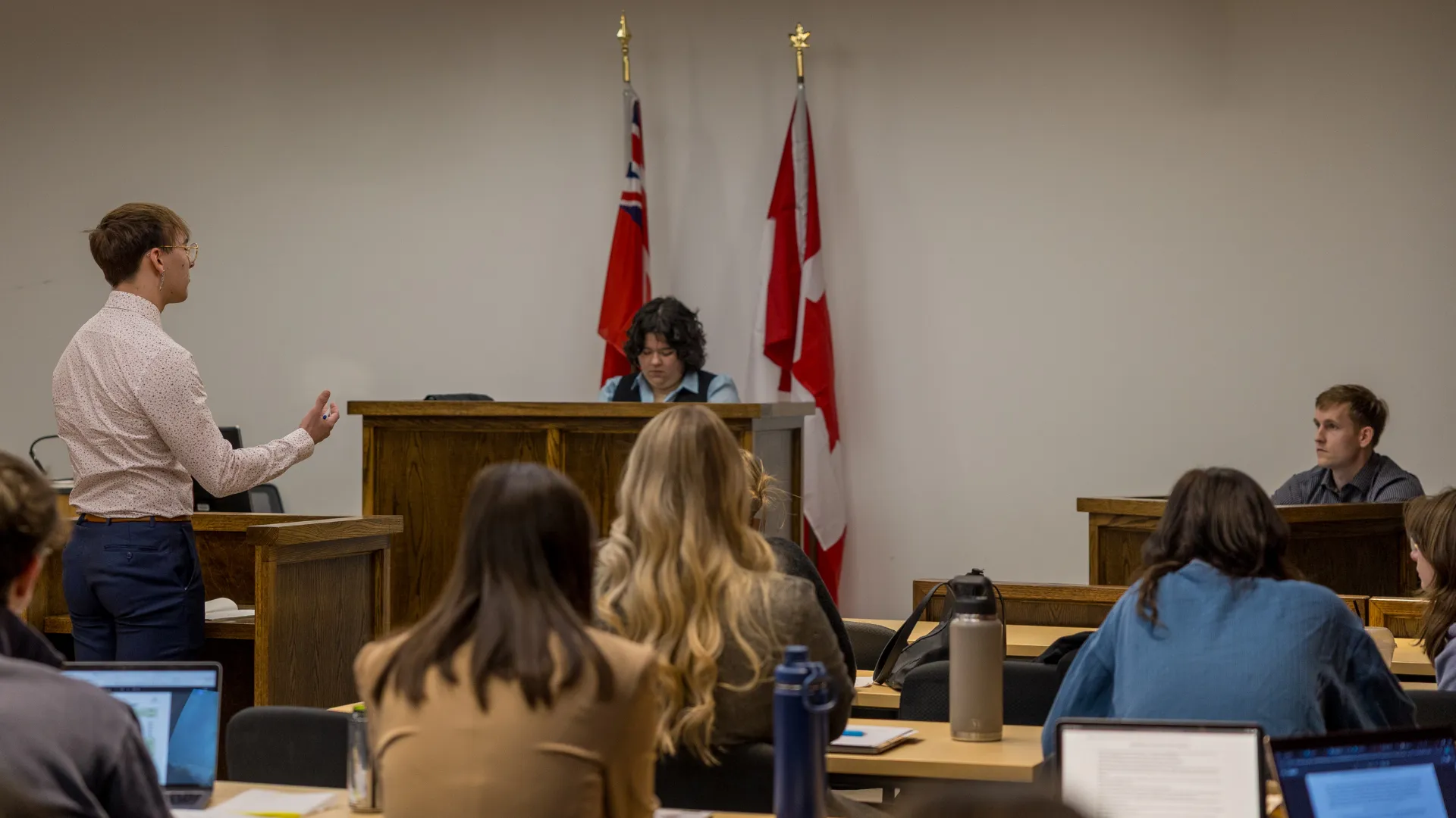 Trent student talking to witness in mock trial.