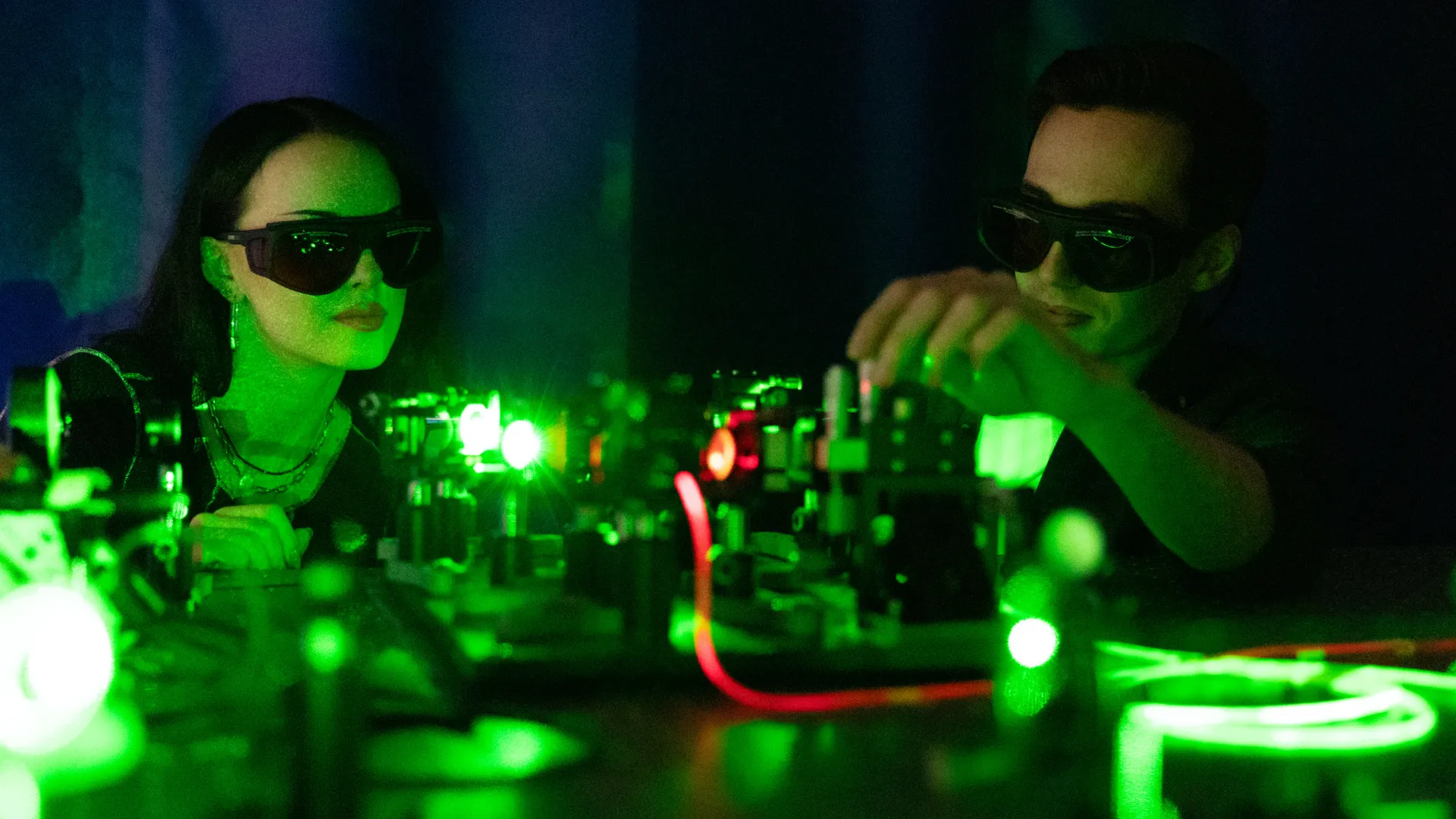 Students in lab using lasers.