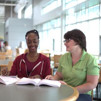 Two students sitting at a table together at Trent Durham
