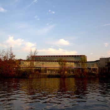 An exterior view of the student center with the river in the foreground