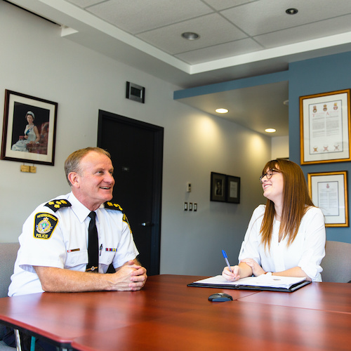 A Peterborough Police Office working with a Trent Research Student