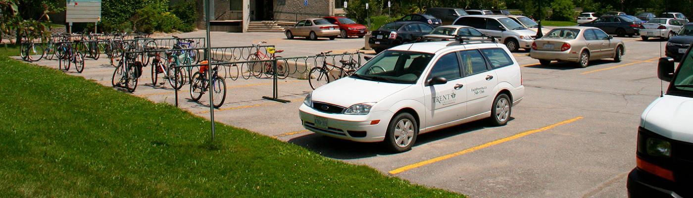white trent vehicle parked in a lot beside bata library