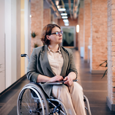 Woman sitting in wheelchair, looking off camera