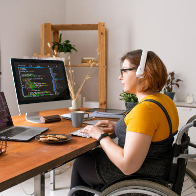 Young woman in wheelchair working at computer