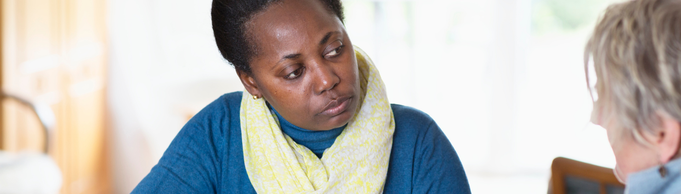 Woman of colour listening intently to older woman