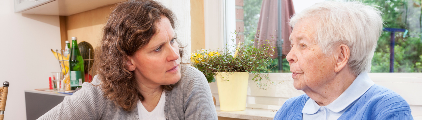 Woman listening intently to elderly woman