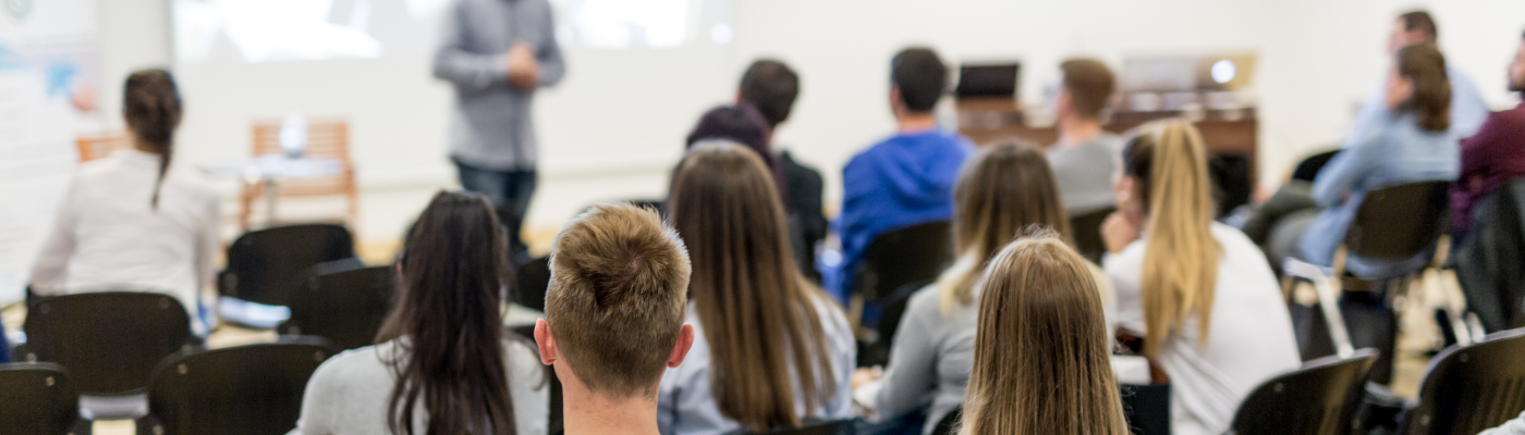 Photo of classroom full of students from the back