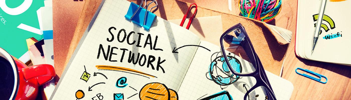 A note pad open on a desk with drawings and sticky notes around it