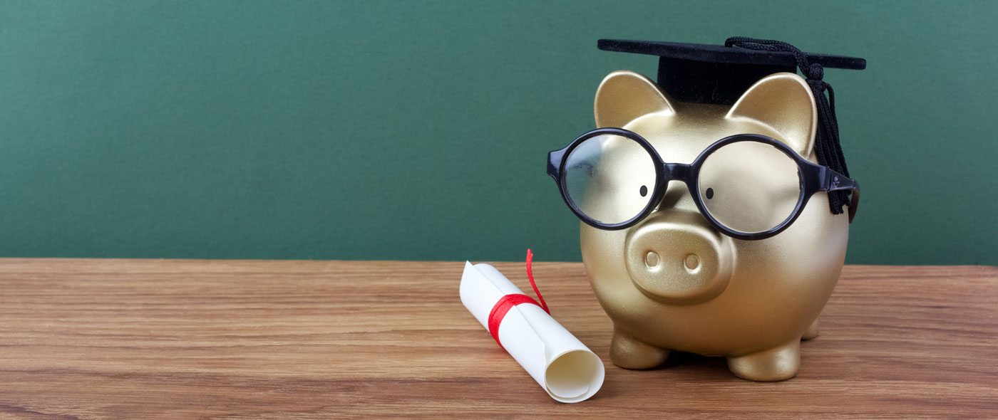 Piggy bank with graduation cap. 