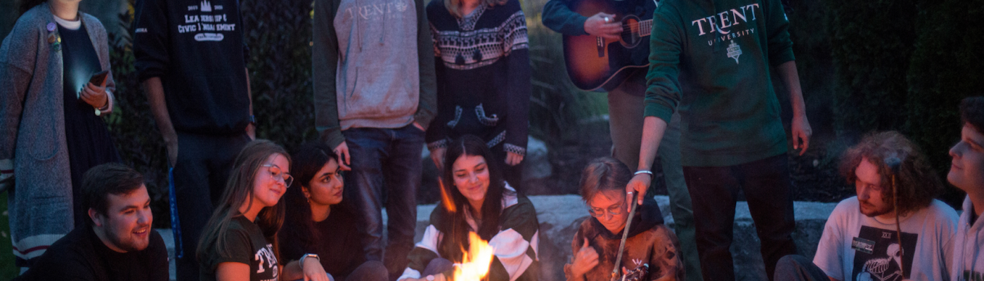 Students sitting around a bonfire