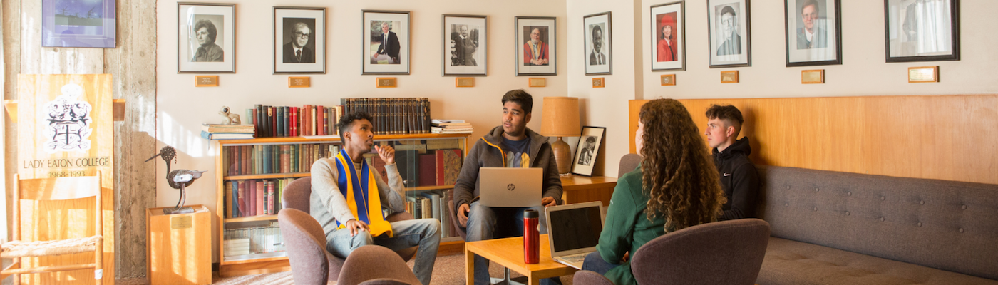 Students sitting around table chatting 