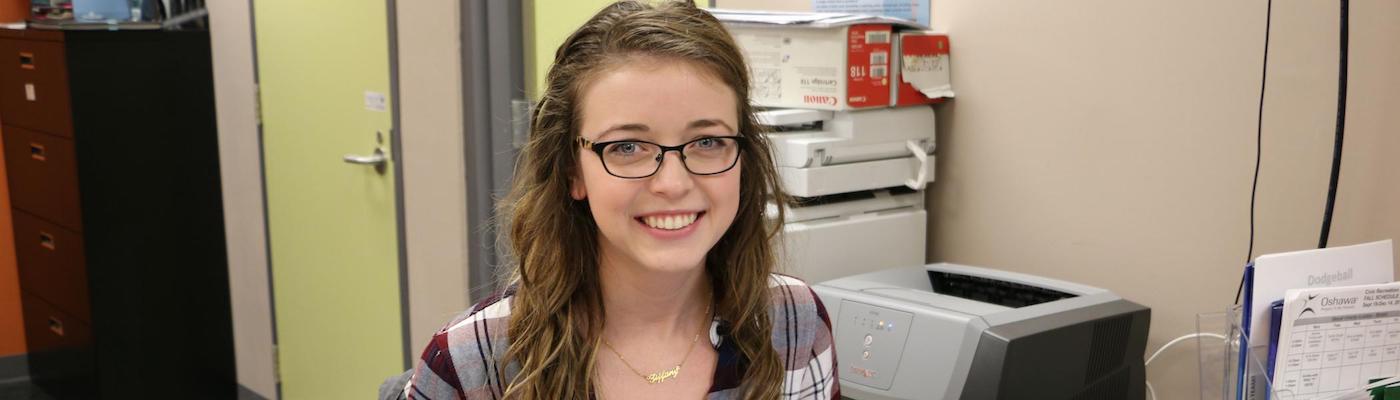 Student working at desk in front of computer