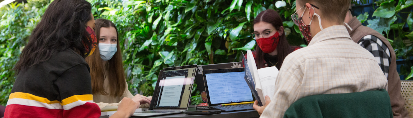 Students sitting around table chatting in the Bata Library