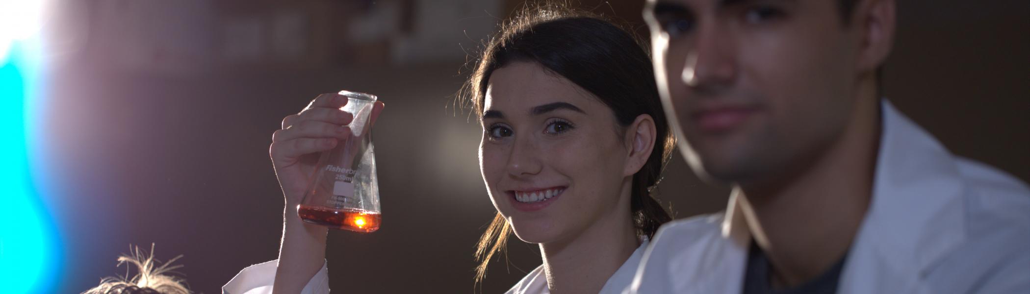 Girl holding beaker in a lab