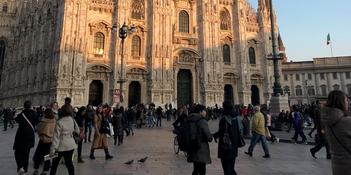 People walking around the plaza by Duomo di Milan.