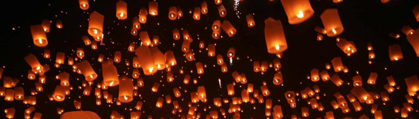 A bunch of lanterns being let go at night