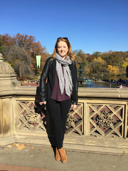 grad student Kristen Potter standing on bridge smiling at camera