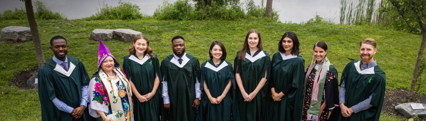 Sustainability Studies students from convocation 2024, smiling at camera in their gowns