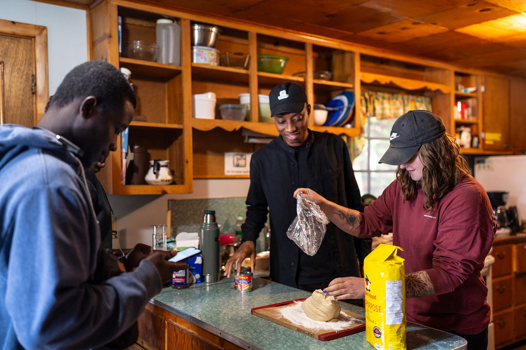 3 students working together to make a group meal