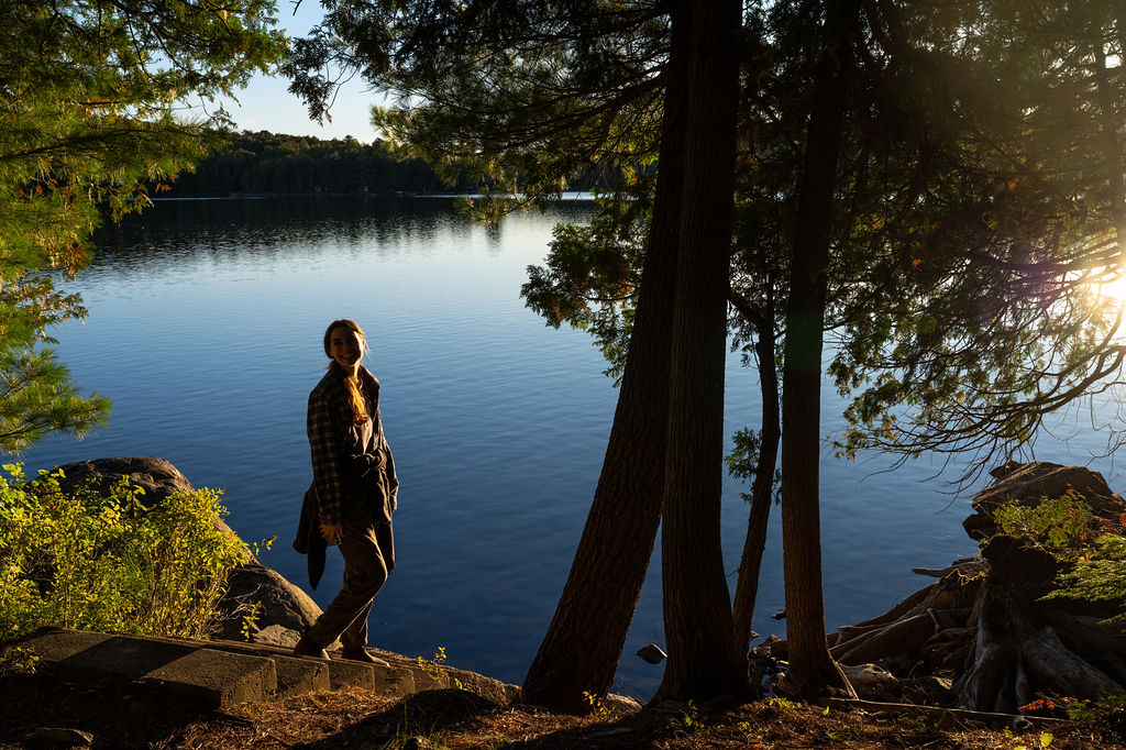 smiling student at the water with sunset