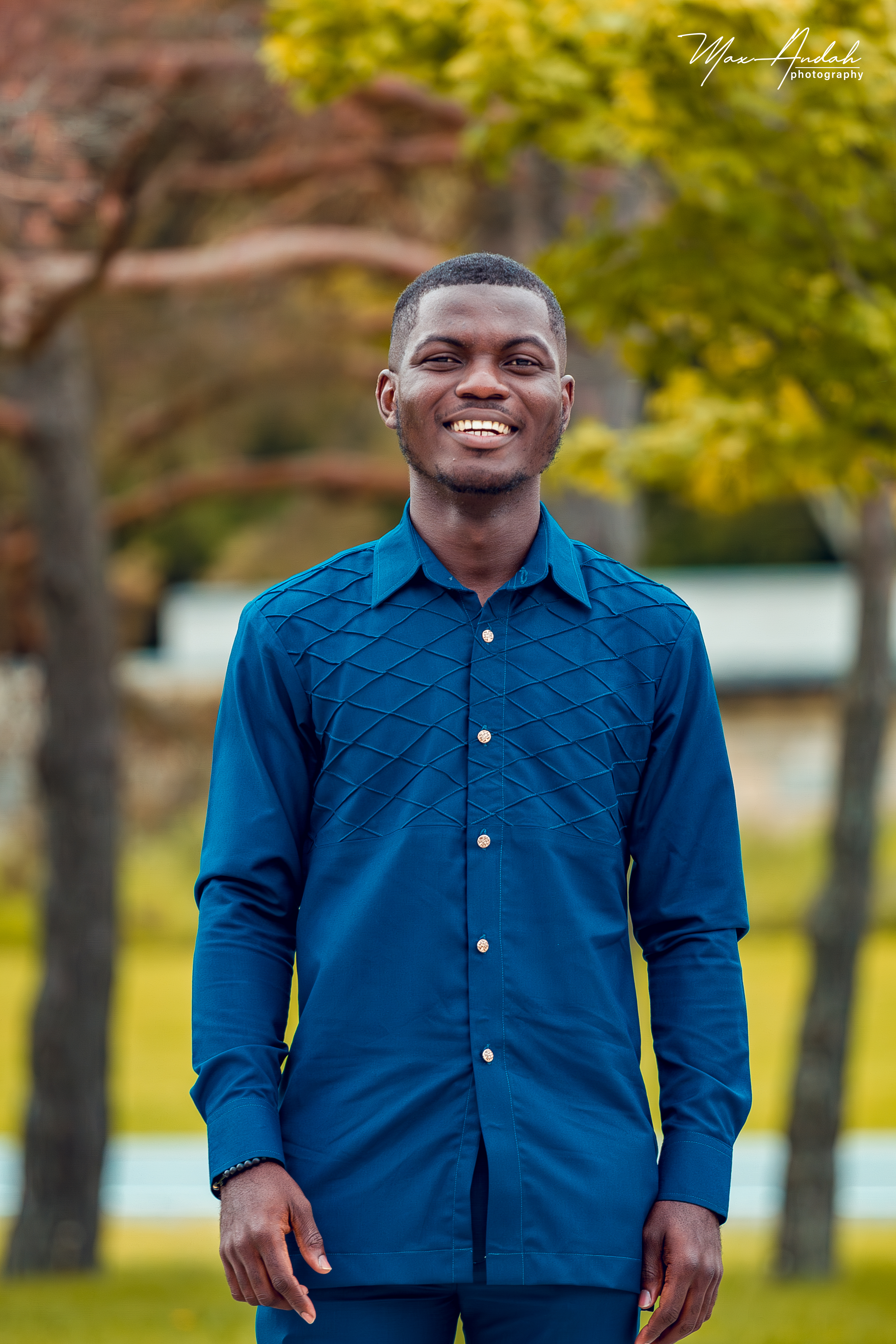 graduate student obed asamoah, smiling at camera outdoors