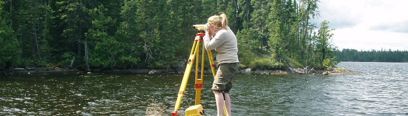 Student conducing survey in lake