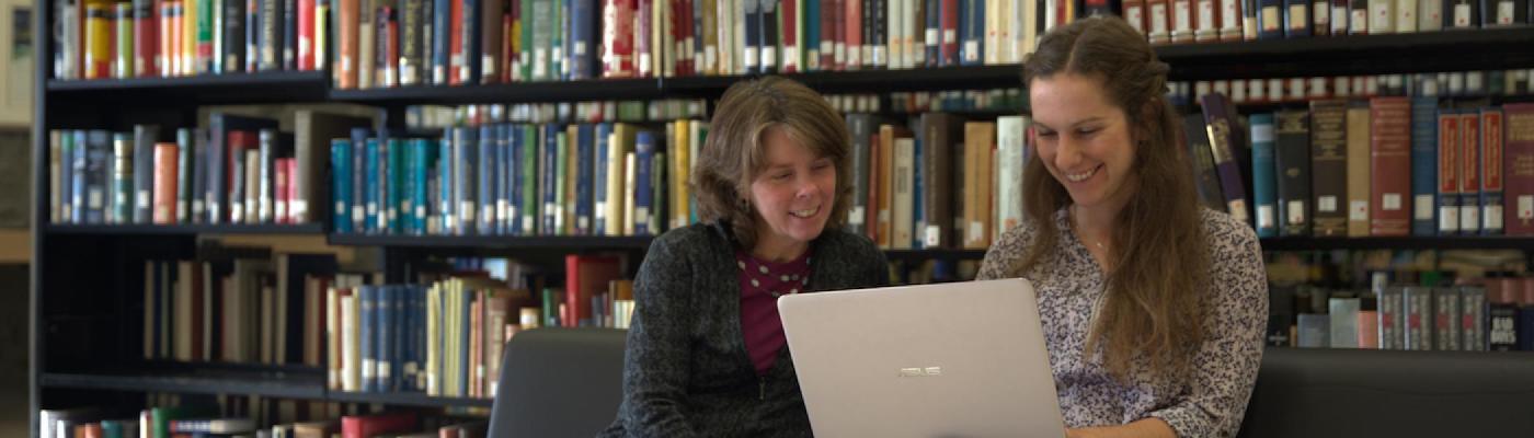 Studying in front of a shelf of books