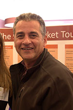 Man with short hair in jacket smiling at the camera