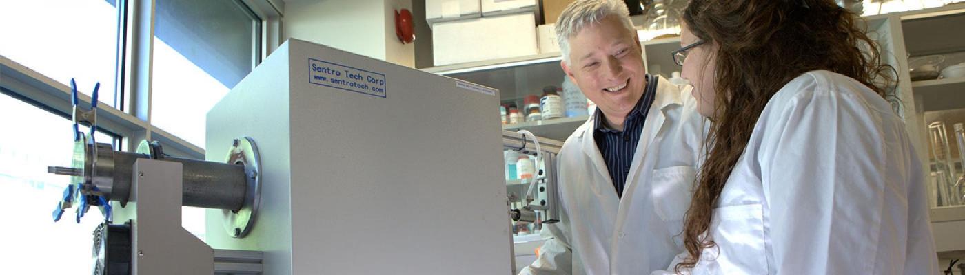 Andrew Vreugdenhil and a student monitoring an instrument.