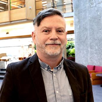 Fergal O'Hagan standing inside Bata Library on a sunny day.